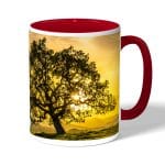 كوب قهوة بمقبض احمر بتصميم شجره الغروب