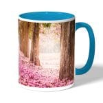 كوب قهوة بمقبض ازرق فاتح بتصميم اشجار الساكورا