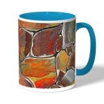 كوب قهوة بمقبض ازرق فاتح بتصميم صخور ملونه