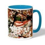 كوب قهوة بمقبض ازرق فاتح بتصميم ورود