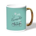 كوب قهوة بمقبض ذهبي بتصميم دراجه هوائيه