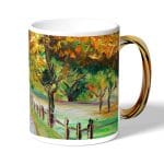 كوب قهوة بمقبض ذهبي بتصميم رسم الطبيعه