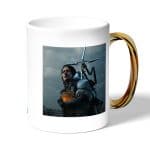 كوب قهوة بمقبض ذهبي بتصميم سام بريدجز ديث ستراندنغ