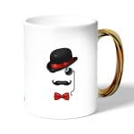 كوب قهوة بمقبض ذهبي بتصميم قبعة وشوارب